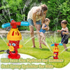 A child is playing with a colorful cartoon fire hydrant water sprinkler toy in a grassy outdoor setting.