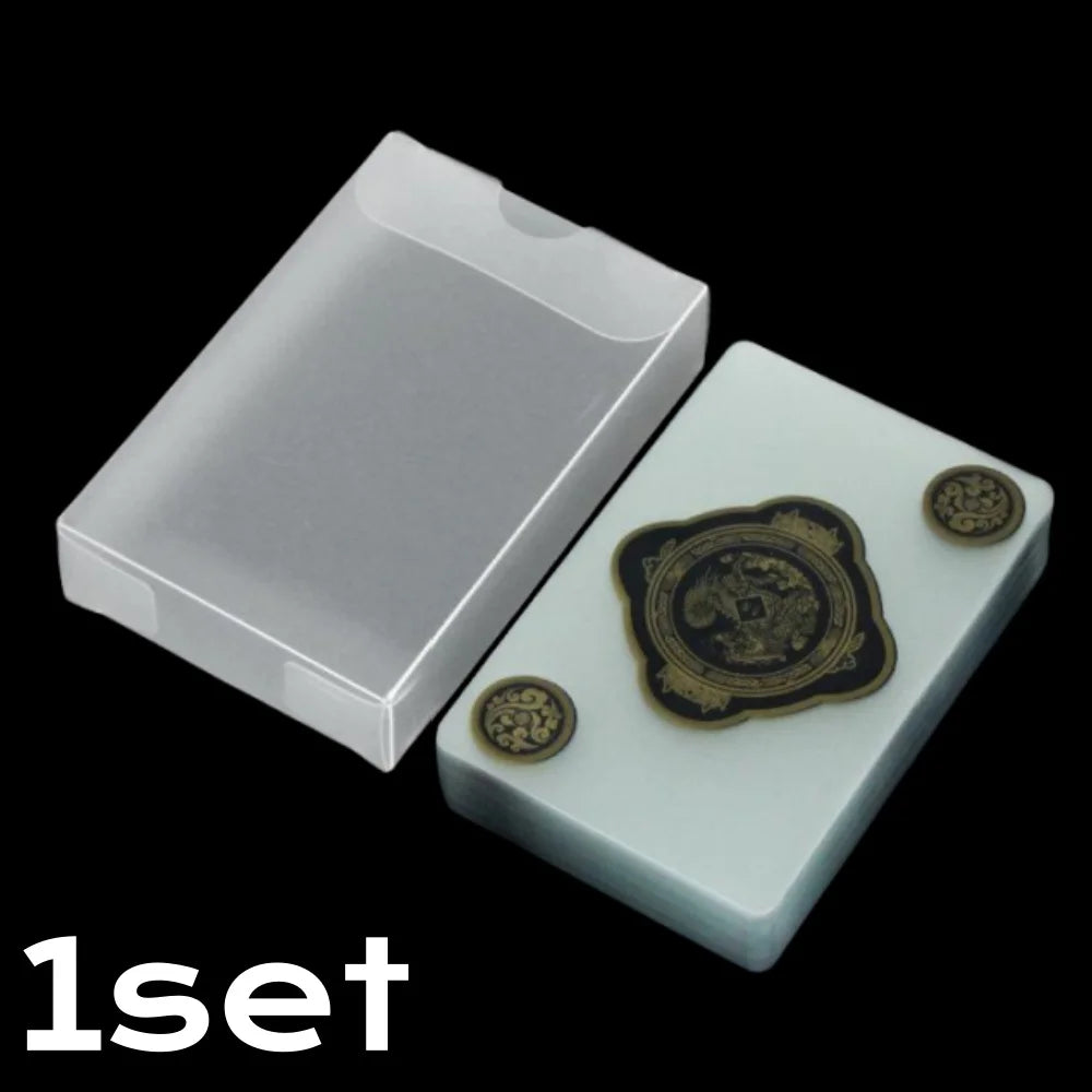 A set of waterproof transparent playing cards displayed in a white holder with gold-edged cards.