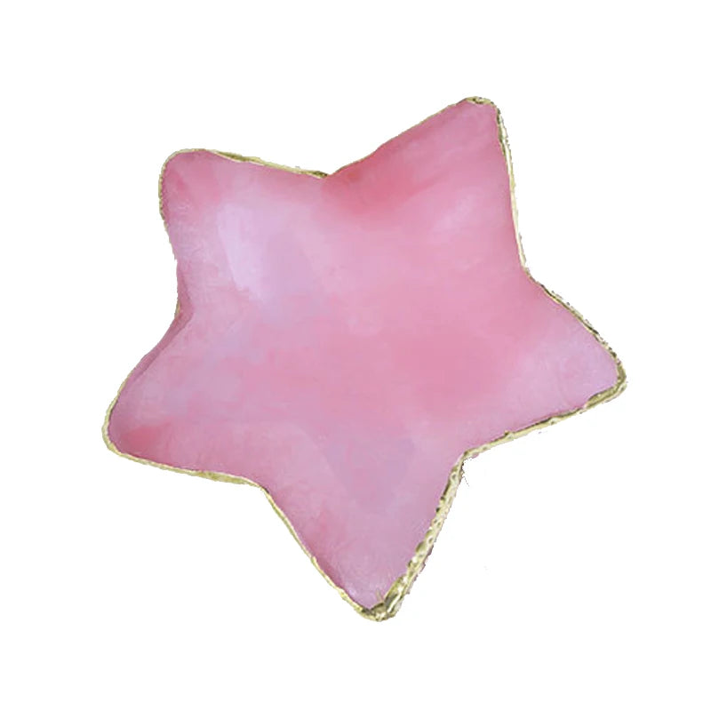 A pink star-shaped resin nail art palette with a gold trim.
