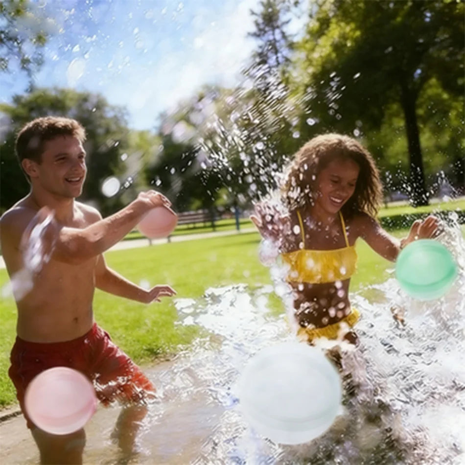 Two people are playing with water balloons in a puddle outdoors on a sunny day.