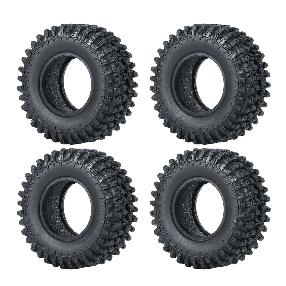 Quatre pneus ou roues en caoutchouc souple pour un véhicule RC crawler, vue de dessus.