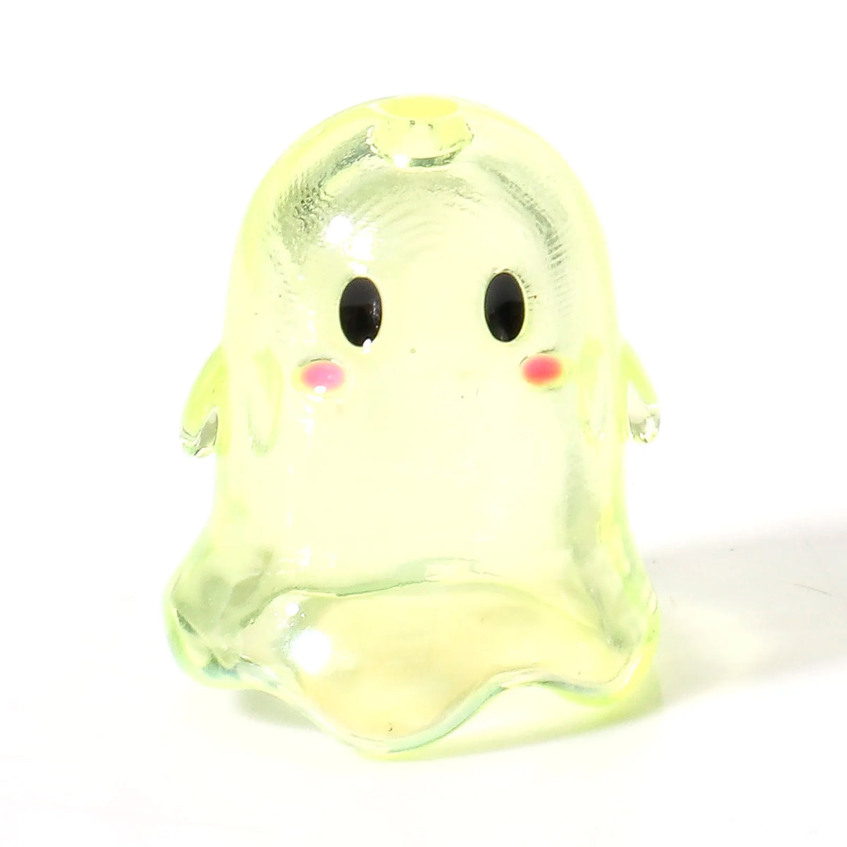 A translucent yellow acrylic ghost bead with black eyes and pink accents.