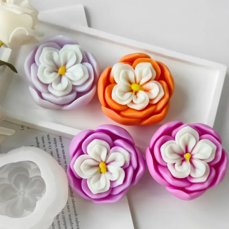 Pink and orange silicone molds shaped like rose flowers for candle and soap making
