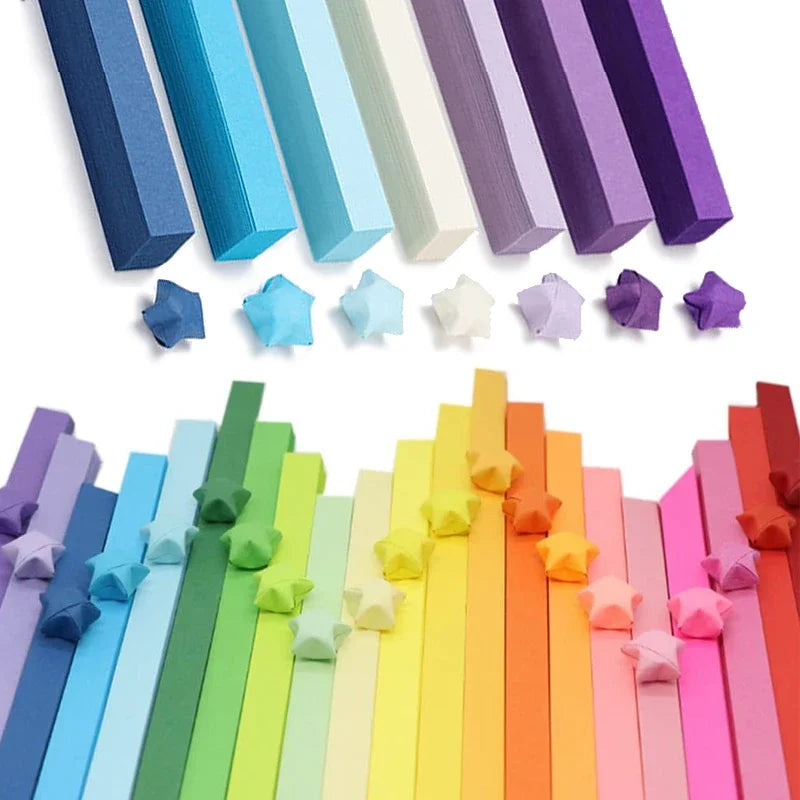 Colorful paper strips in various shades of blue, purple, green, and orange, arranged in a gradient.