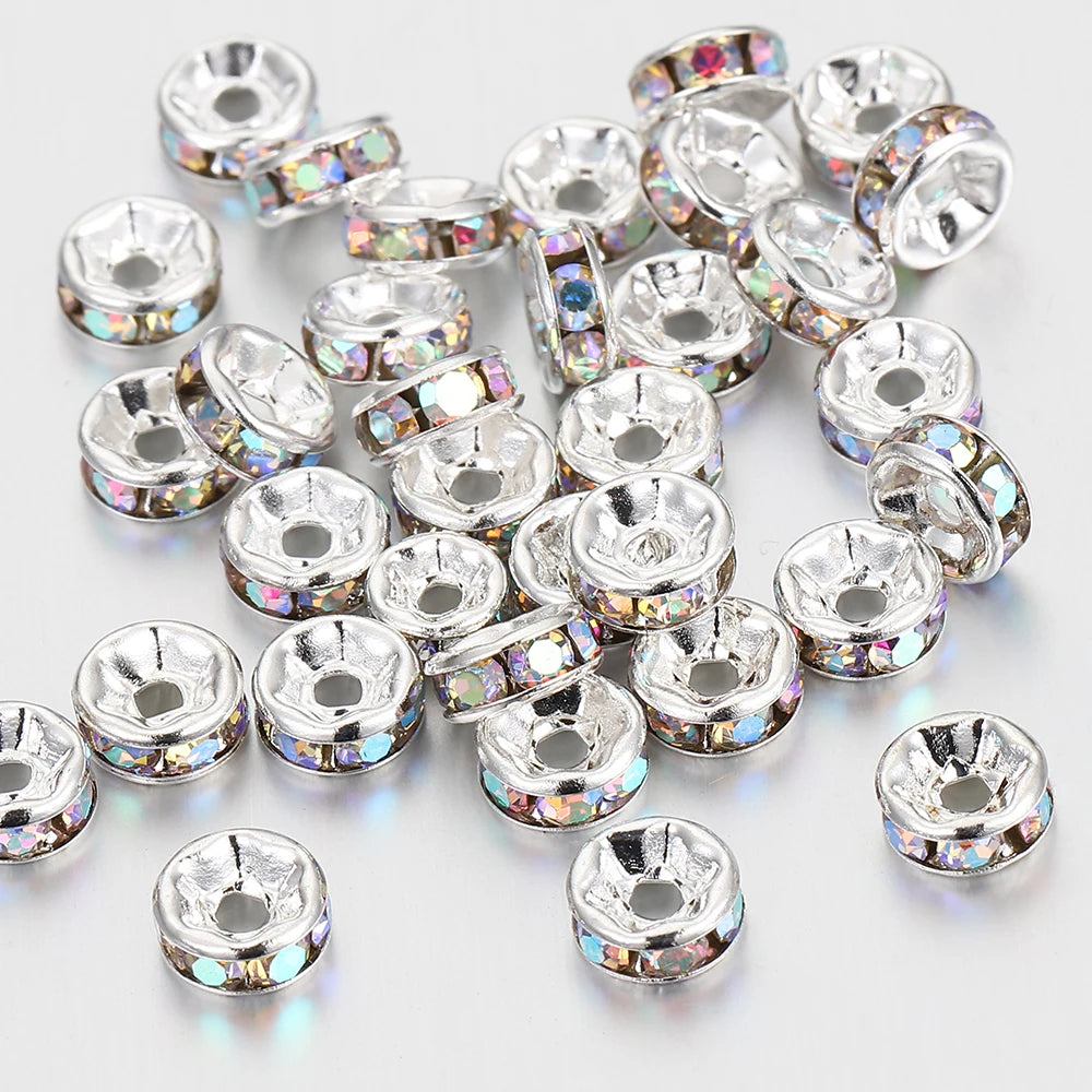 A collection of silver crystal rondelle spacer beads for jewelry making, displayed on a white background.