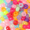 A close-up view of a large pack of colorful rainbow pony beads in various shades of pink, purple, yellow, and green.