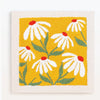 Yellow punch needle embroidery featuring white and red daisy flowers on a beige background.