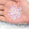 A handful of small, translucent pink and purple sakura flower crystal glass beads for jewelry making