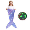 A purple glow-in-the-dark mermaid tail blanket for kids with a green glowing starfish.