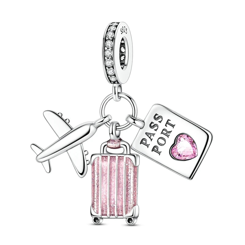A silver charm featuring a heart bead and a passport tag, designed for jewelry.