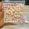 A clear plastic bag filled with numerous pastel-colored squishy toys shaped like cat paws.