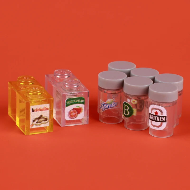 A collection of clear and colored plastic building blocks, including food items like pizza, cake, and condiment bricks.