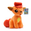 An orange and red plush doll resembling a cat or fox with large ears and a tuft of hair, next to a small card.