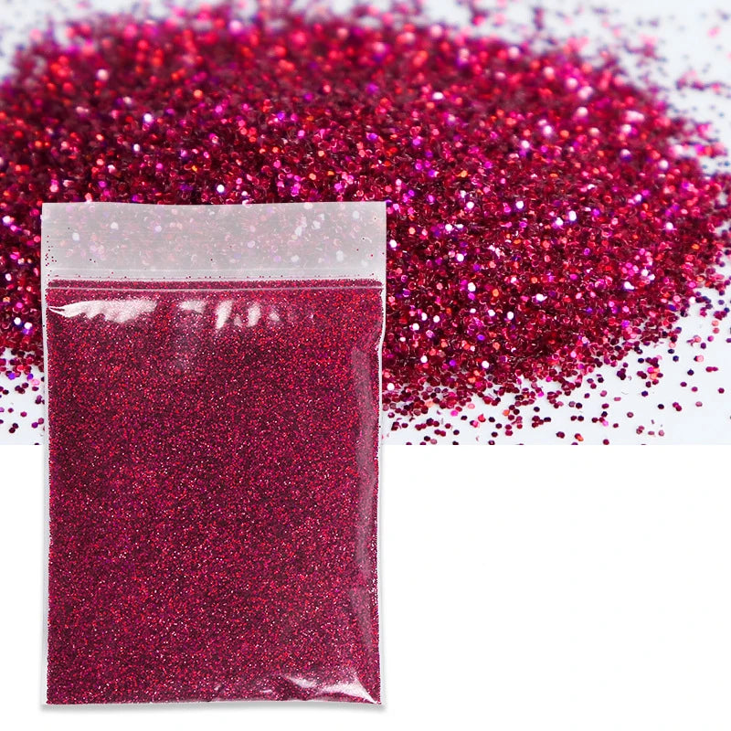 A sealed bag of vibrant magenta glitter powder scattered across a white background.