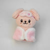 A pink fluffy cartoon animal plush keychain with large ears and a small pink bow.