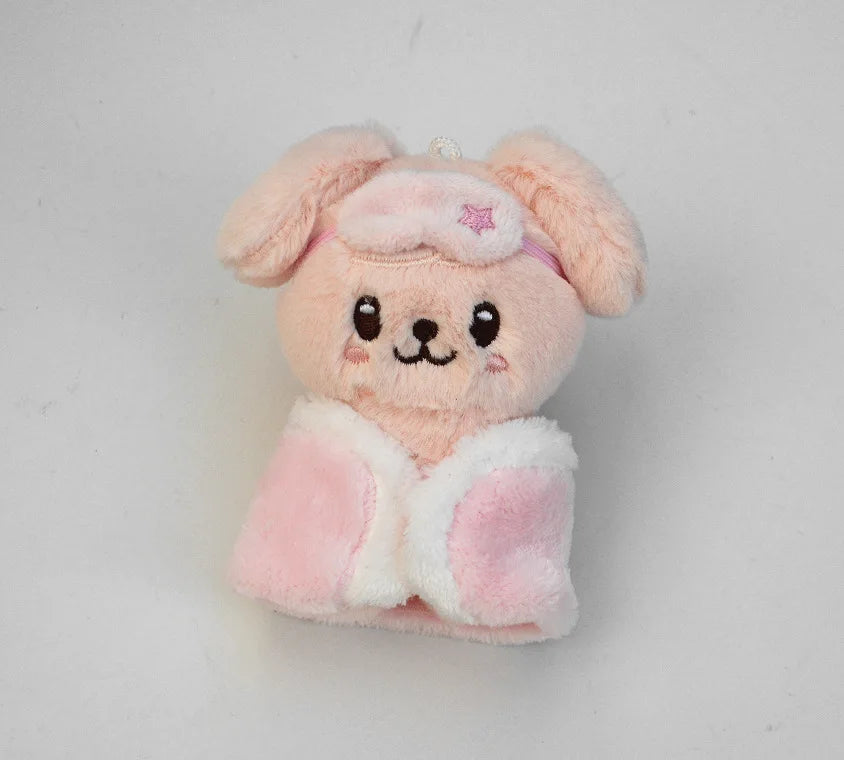 A pink fluffy cartoon animal plush keychain with large ears and a small pink bow.