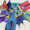 A collection of colorful 3D origami paper airplanes made from various colored paper, including red, blue, green, and purple.