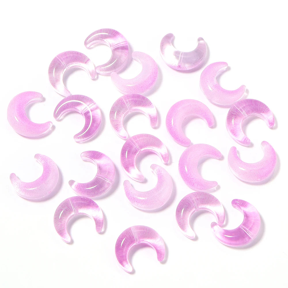 A collection of pink moon-shaped glass beads for DIY jewelry making