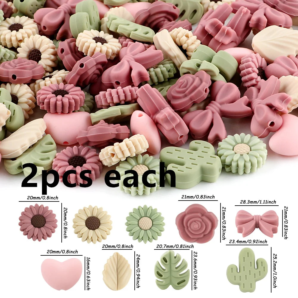 A variety of pink and green silicone flower and leaf beads for jewelry making are shown in loose piles and individual example