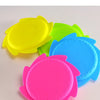 A collection of brightly colored silicone splash flying rings in yellow, green, and blue, used for water play.