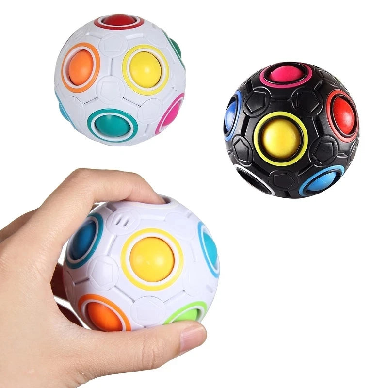A hand holds a colorful rainbow antistress cube fidget toy with multiple colored spheres.