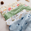 A collection of cute waterproof baby bibs with long sleeves featuring various animal patterns and pastel colors.