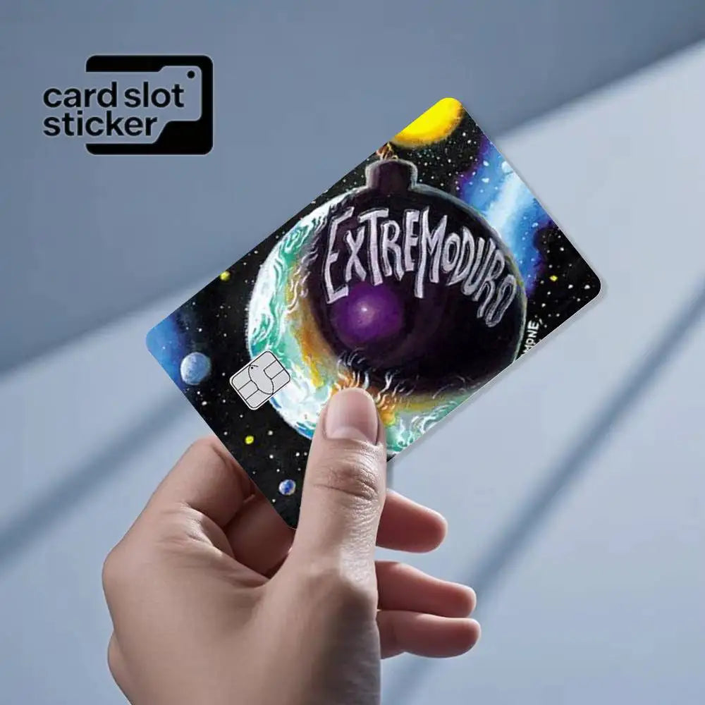 A hand holds a square card slot sticker featuring a purple planet and the text EXTREMODURO against a starry background.