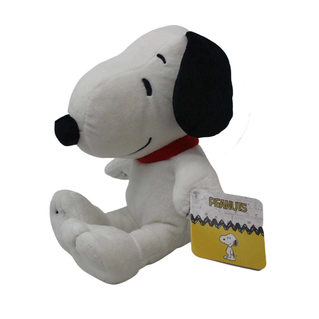 A white Snoopy plush toy with black ears and a red collar sitting down.