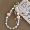 A necklace featuring pink and clear pearl crystals and a star charm attached to a bag clip.