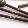 Three brown gel pens with Japanese characters are displayed on a white surface.