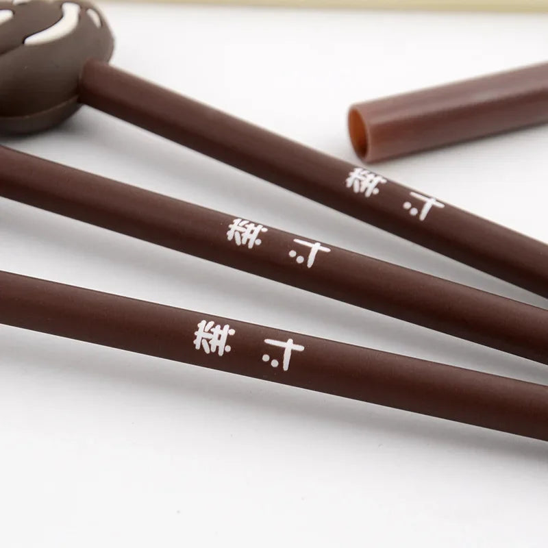 Three brown gel pens with Japanese characters are displayed on a white surface.