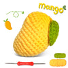 A yellow crochet fruit, likely a mango, is shown next to a crochet hook and yarn.