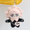 A plush pendant doll of a female character with pink hair and black clothing.