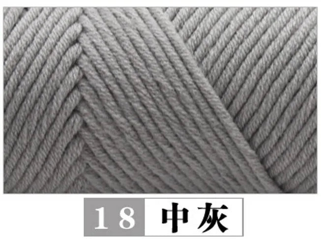 Close-up texture of gray premium milk cotton yarn used for knitting or crafting.