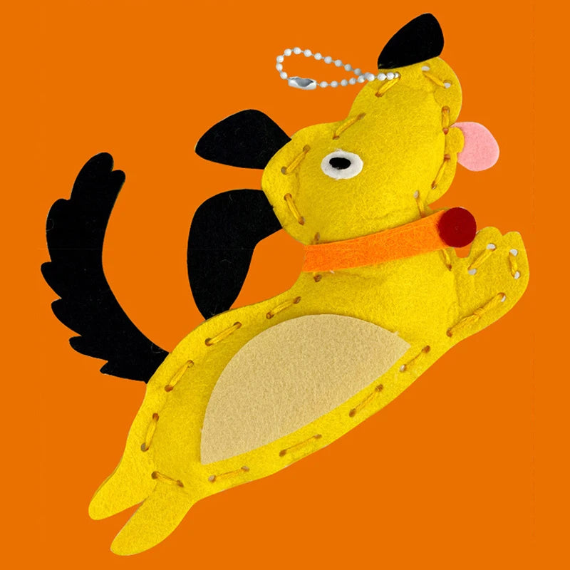 A yellow felt animal craft kit resembling a stylized, winged creature with black accents and an orange collar.