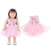 A doll wearing a pink unicorn skirt outfit with a matching top and sheer overlay.