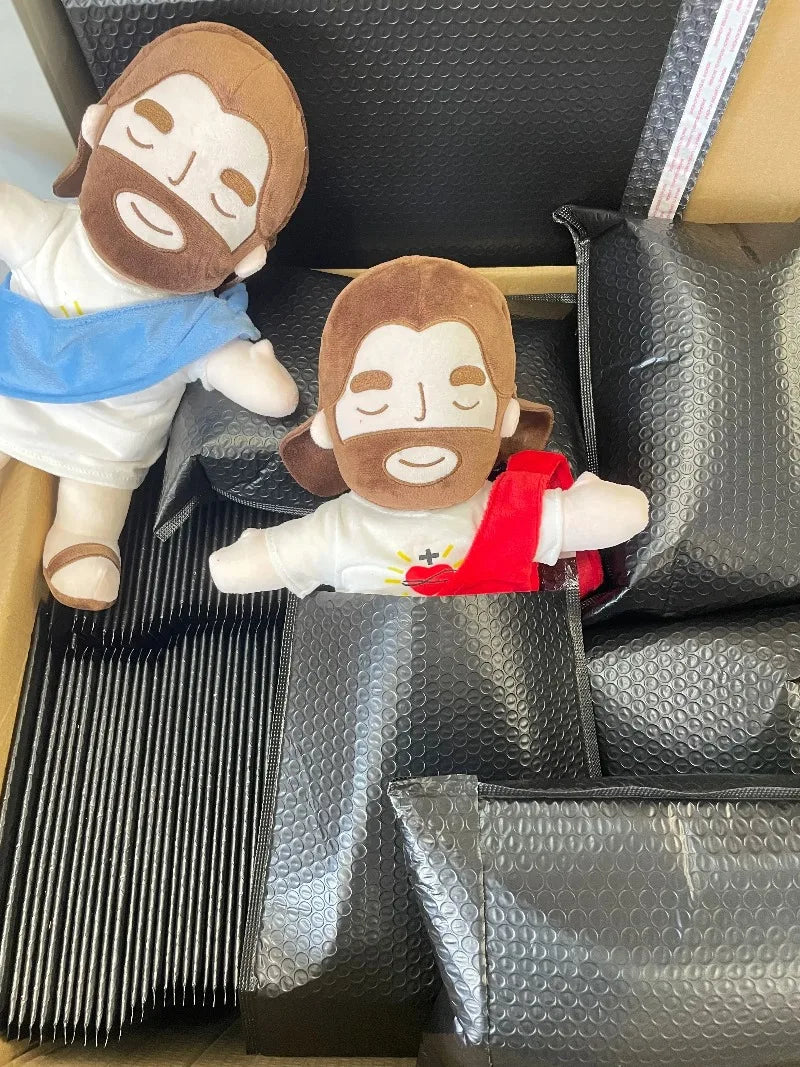 A plush toy depicting a man with a beard and brown hair, wearing a white shirt and blue cloth, is shown in a black box.