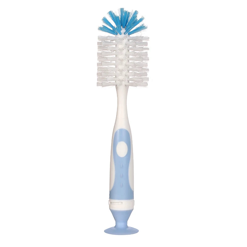 A white baby bottle cleaning brush with blue bristles and a suction stand.