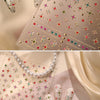 Close-up of sparkling 5D diamond nail art stickers on a translucent sheet with gold accents.