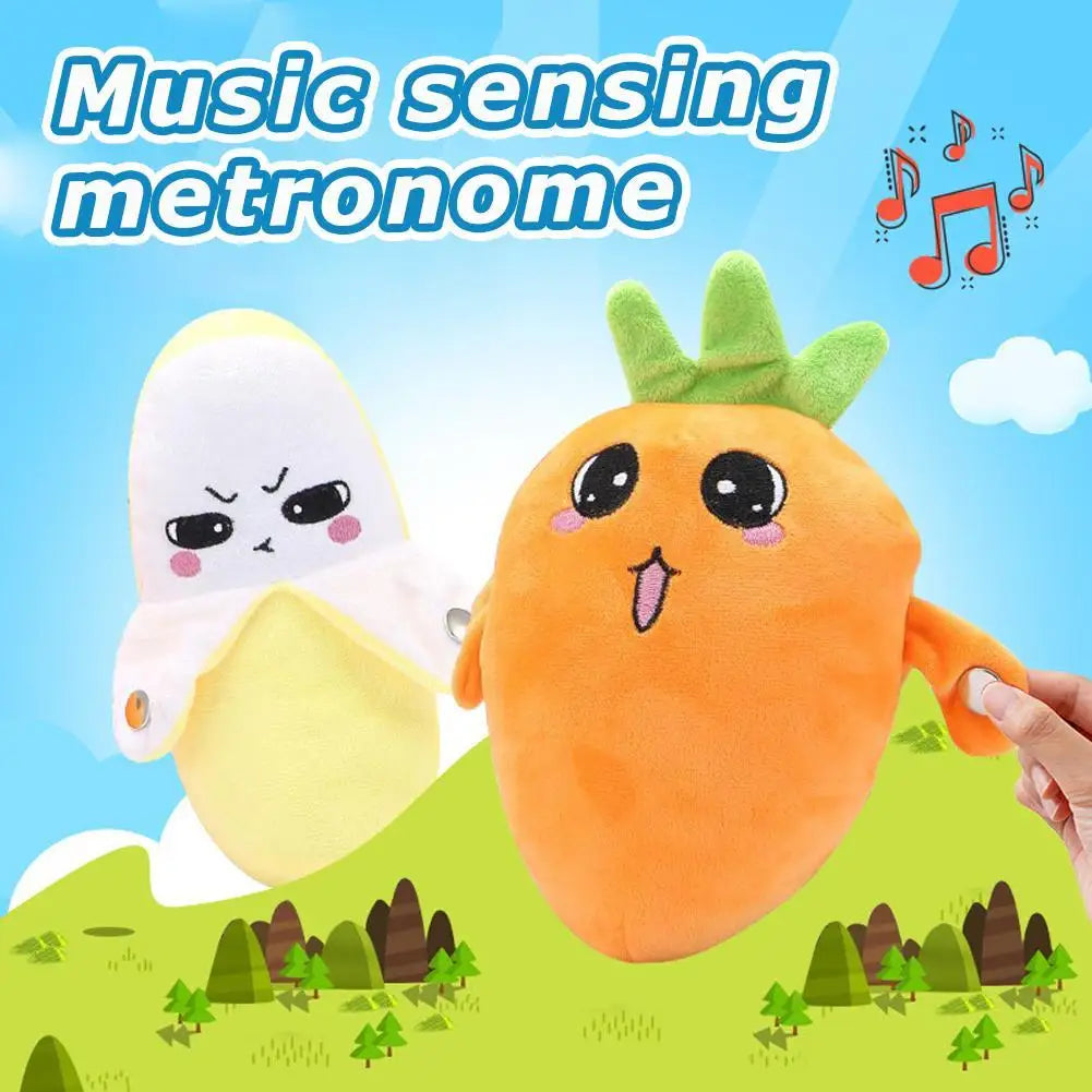 An orange plush toy shaped like a carrot is shown next to a white plush toy, demonstrating a music sensing metronome.