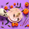 A collection of lifelike fake cockroach props, including insects and skeletal remains, arranged on a purple background.