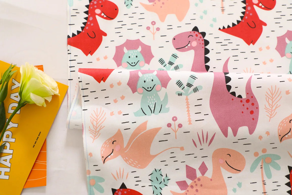 A fabric featuring a colorful dinosaur grid print with various pink, orange, and green dinosaurs.