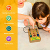 A young girl is interacting with a wooden light-up busy board while practicing hand eye coordination and sensory activities.