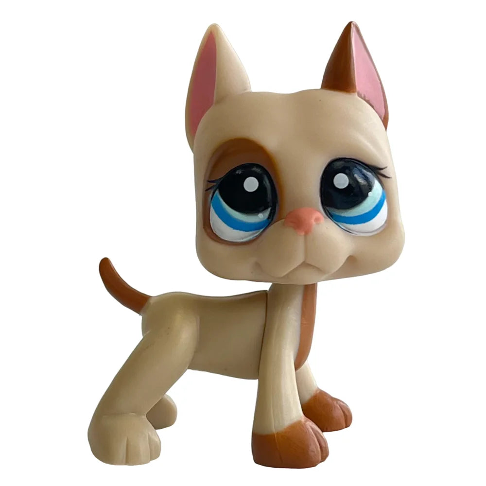 A charming bobblehead figurine of a light tan kitten with blue eyes and pink ears.