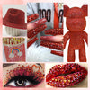 A collection of flatback resin rhinestones in various shades of red and pink used for DIY crafts.