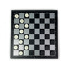 A foldable magnetic checkers board game set with black and white pieces displayed on a dark surface.