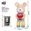 A cute bear figure made of micro building blocks, featuring pink and yellow colors.