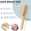 A wooden baby hair brush and comb set with a natural beech wood handle shown next to an infant's face.