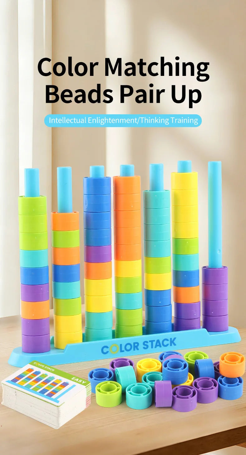 A set of colorful stacking beads in various colors and sizes arranged vertically and scattered on a wooden surface.