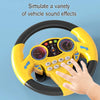 A hand is gripping a yellow interactive steering wheel toy, simulating vehicle sound effects.
